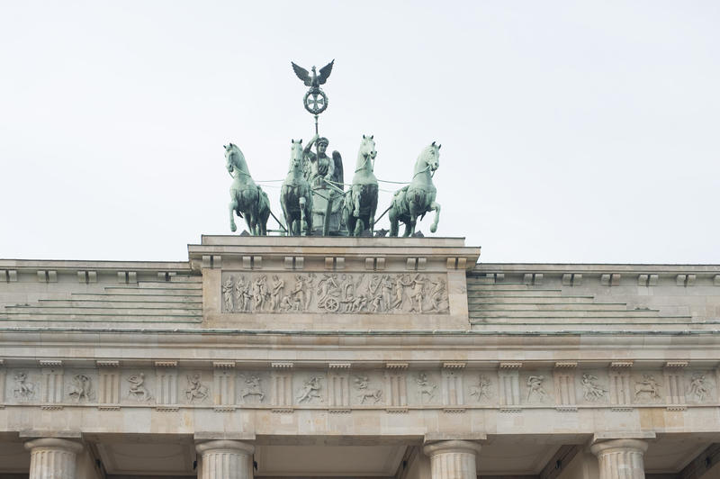Quadriga, Brandenburg Gate, Berlin which is a triumphal quadriga with the statue of Victoria carrying a staff with a winged bird and four horses drawing the chariot