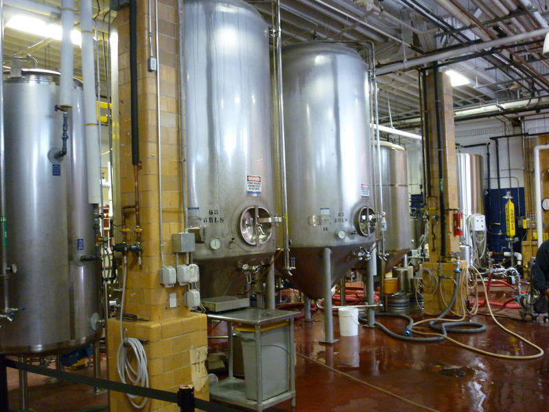 Interior view of large metal brewery vats for the fermentation of the malt to produce ale and beer