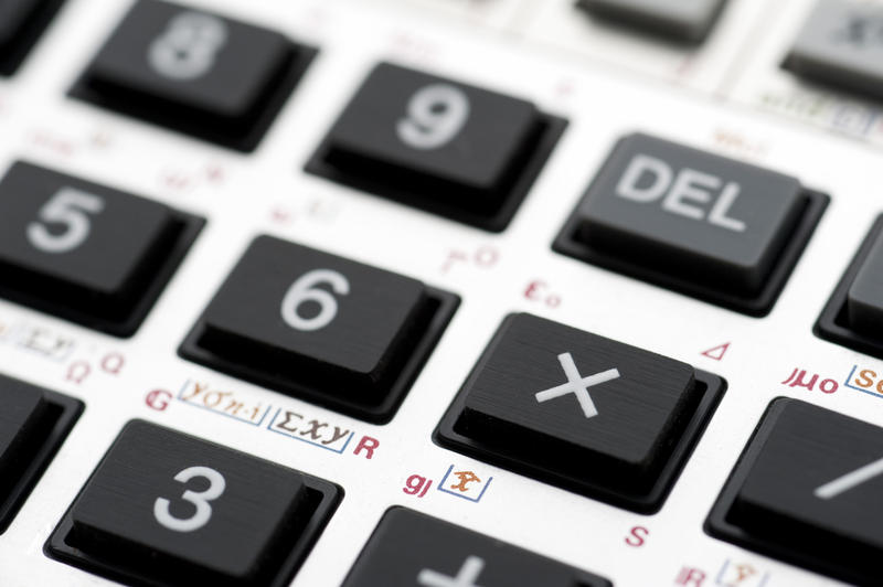 Closeup of the keypad of a calculator with focus to the multiply key