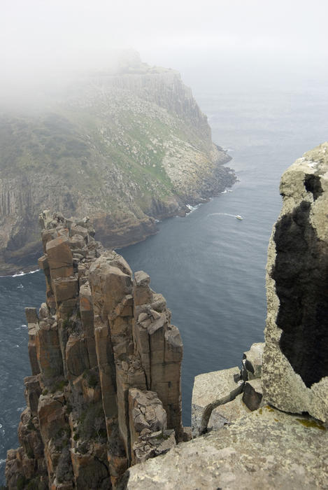 looking down from the blade, tasman peninsula with tasman island in the distance shrouded in mists