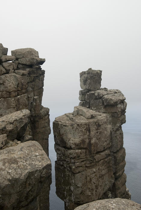 free standing rock formations perched high on the cliffs of cape pillar, tasmania