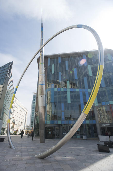 The stainless steel and enamel hoop and arrow column of the Alliance sculpture in urban Cardiff, Wales