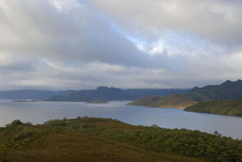 a panoramic view of lake pedder with dramatic storm clouds