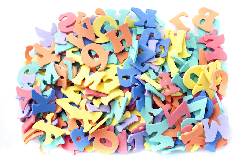 a pile of rendom coloured letters on a white background