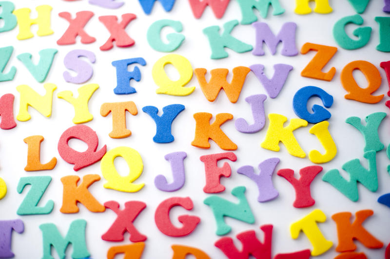 Spread out multicolored plastic letters of the alphabet