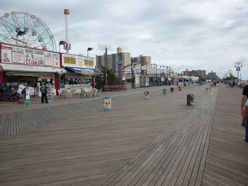 View along the Broadwalk, Coney Island showing the snack shops and top of the Wonderwheel ferris wheel in the Astroland amusement park