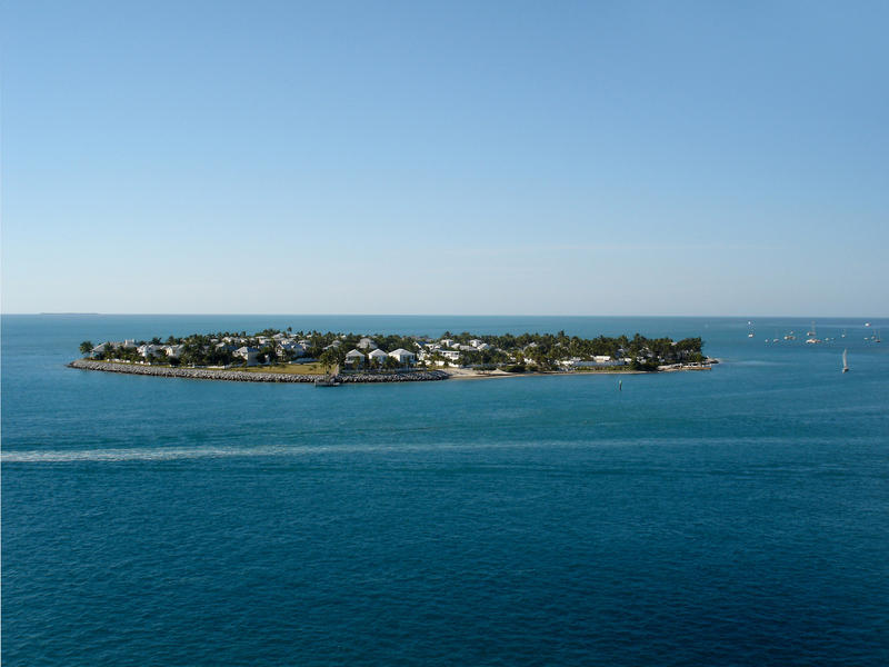 a small low laying coral island with houses