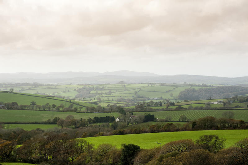 Cornwall country landscape with gently rolling hills and lush green agricultural fields and pastures