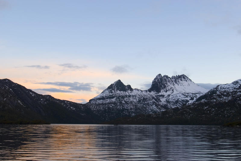 snow contrasts against the dark silhouette at sunset of cradle mountain, Cradle Mountain-Lake St Clair National Park