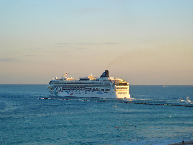 Huge passenger cruise liner putting out to sea on a holiday voyage in late evening light