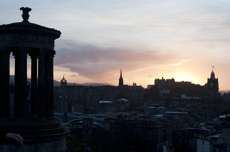 View from the Dugald Stewart Monument on Carlton Hill of Castle Rock Edinburgh silhouetted at sunset