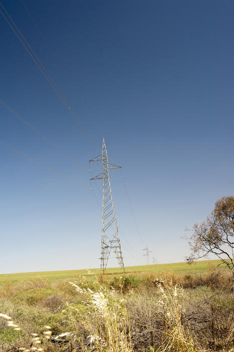 electric power lines running through an unspoilt rural landscape
