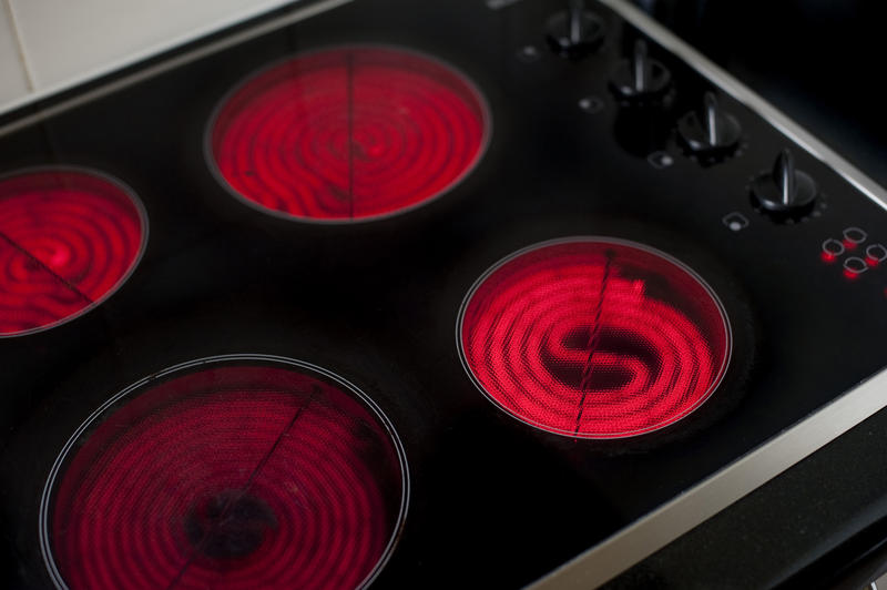 a glass electric stove top with the heating rings switched on