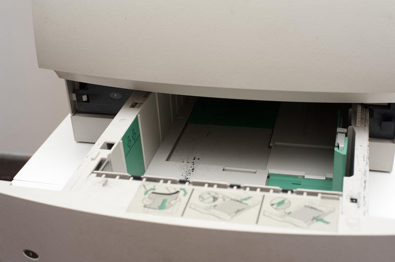 Empty paper drawer on an opened photocopier or printer in an office
