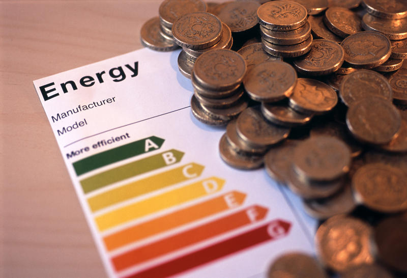 concept image of an appliance energy efficience rating label and a pile of uk money