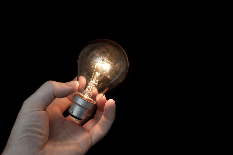 a light globe seemingly spontaneously glowing in someones hand