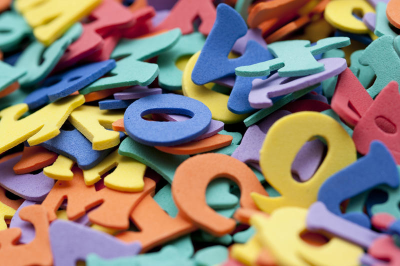 Education background conceptual of teaching the English language with a jumbled pile of colourfull uppercase alphabet letters