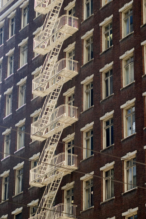 external fire escape stairs on the side of a tall building in san francisco
