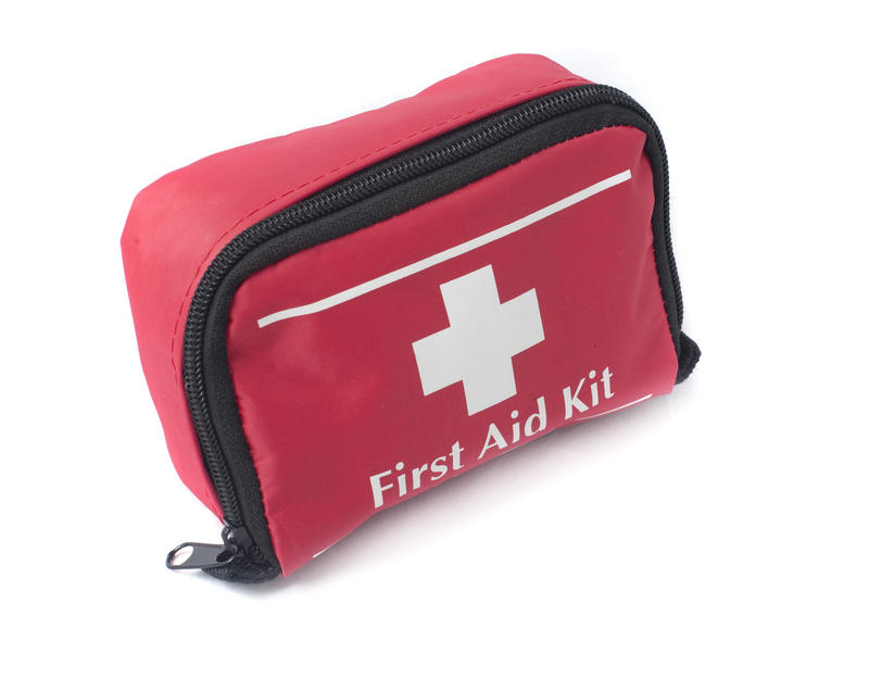 A red colored first aid bag with medical supplies inside
