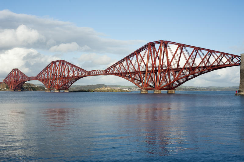 a sunny day view of the massive piers of the forth bridge and spans between