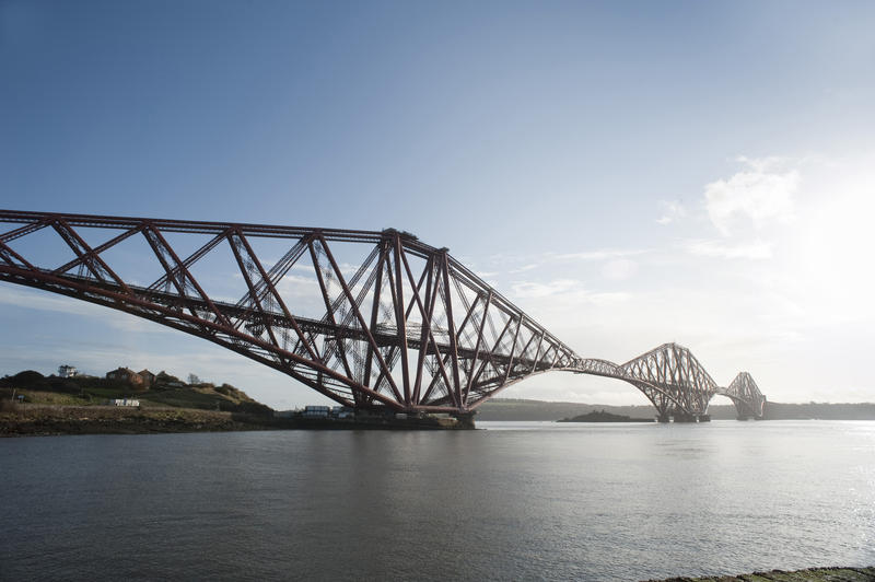 View looking across the water of the Firth of Forth to the iconic cantilever Forth Rail Bridge, Scotland