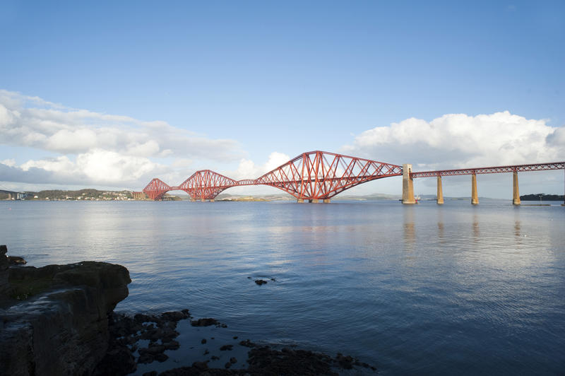 View looking across the water of the Firth of Forth towards the Forth Rail Bridge, a historical landmark outside Edinburgh