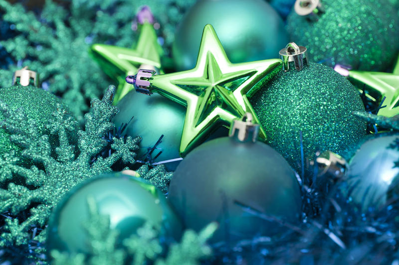 Collection of festive green Xmas decorations including, baubles, balls, snowflakes and symbolic Christmas stars