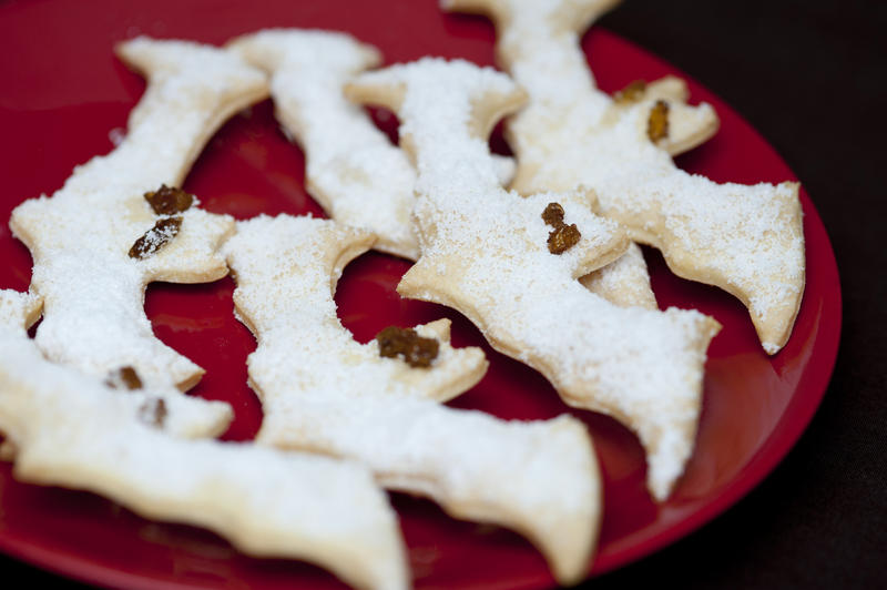 a plate of bat shaped homemade halloween cookies to give to trick or treaters