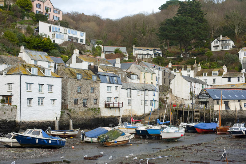 View of the harbour and waterfront of Polperro village, Cornwall which is a quaint unspoilt fishing village which is a popular tourist destination that has managed to retain its charm