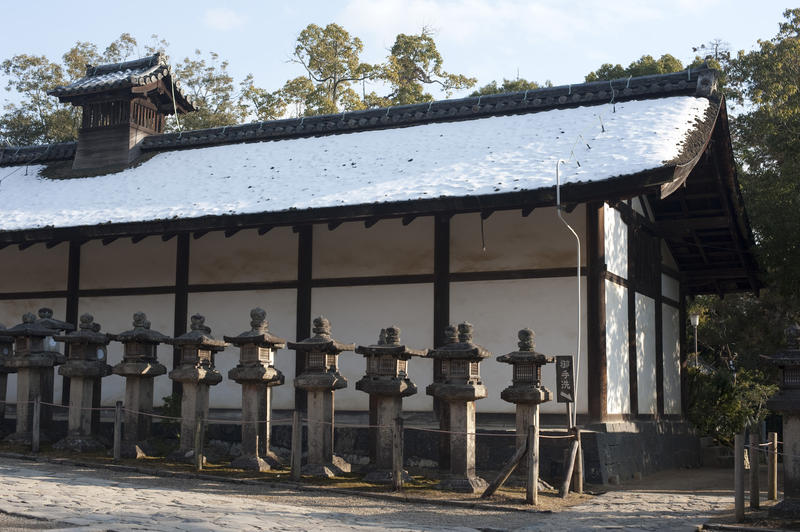 the sakadono building at kasuga taisha shrine covered in snow