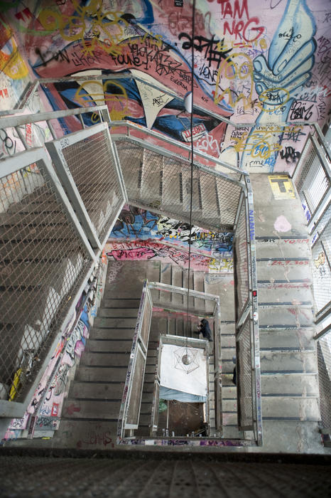 View looking down of an Interior staircase adorned with grafitti at the Kunsthaus Tacheles art squat in Berlin