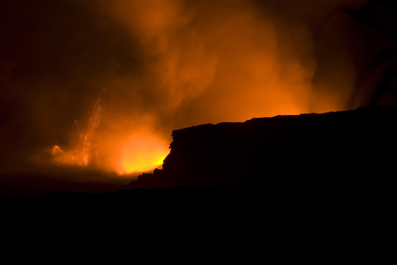lava erruption spewing clouds of steam and hot volcanic gasses, near Kalapana, Hawaiis Big Island