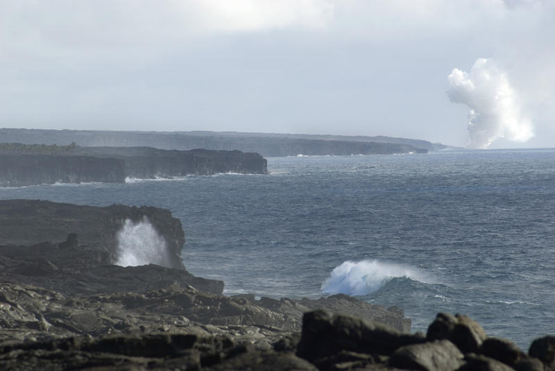 volcanic steam billowing into the air where the a lava flow meets the ocean, Hawaii