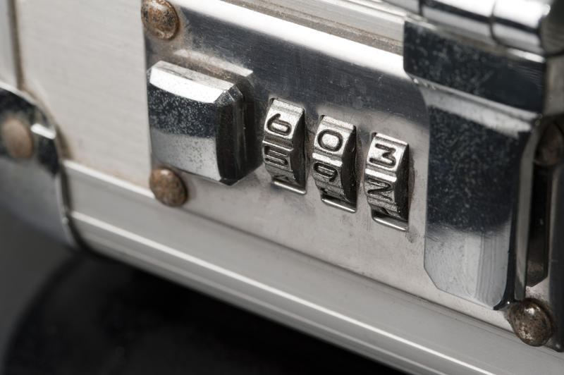 Combination lock on an attache case with revolving numbers preset to a personal code increasing security and safety