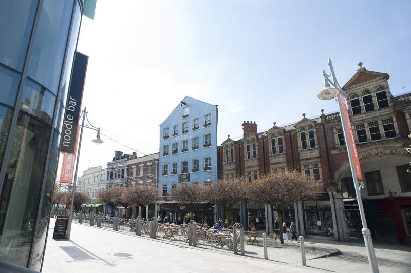 View along the street of the external facades of historical buildings lining the road in Mill Lane Cardiff, Wales