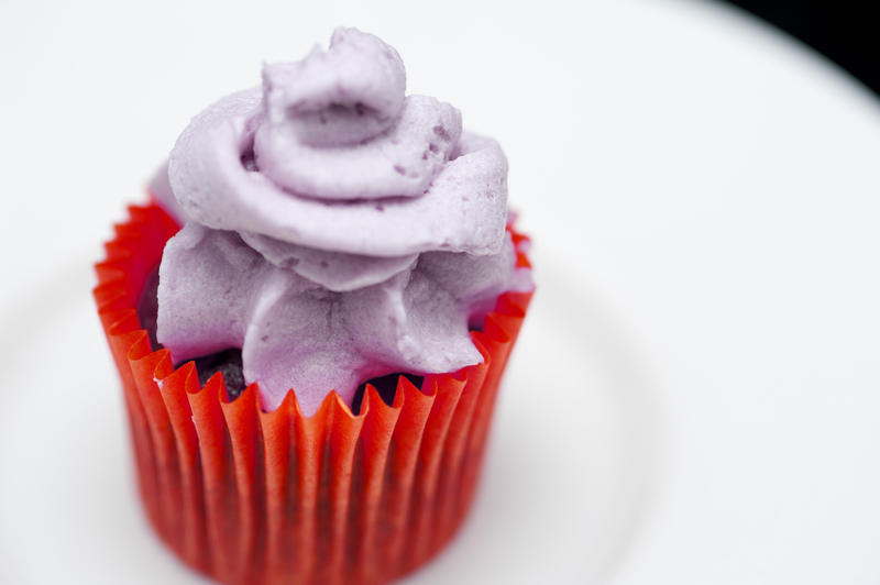 close up image of a small iced cup cake