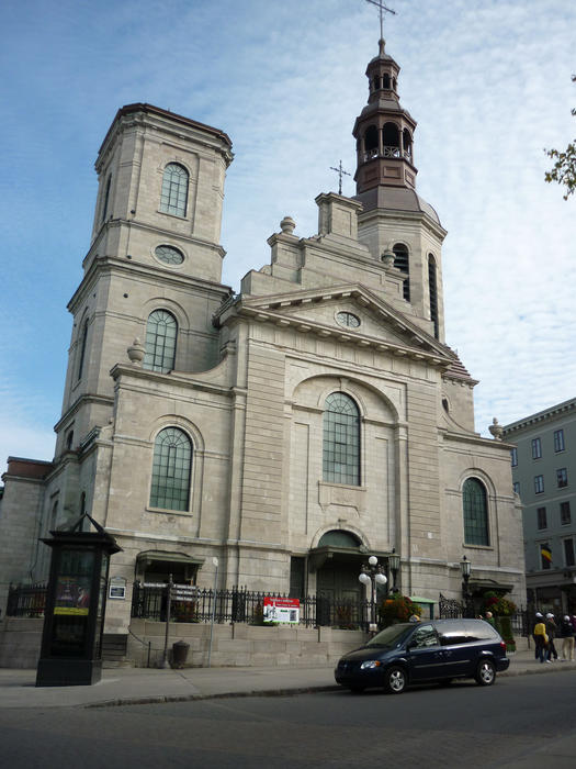Street view of the exterior stone facade of Notre Dame de Quebec