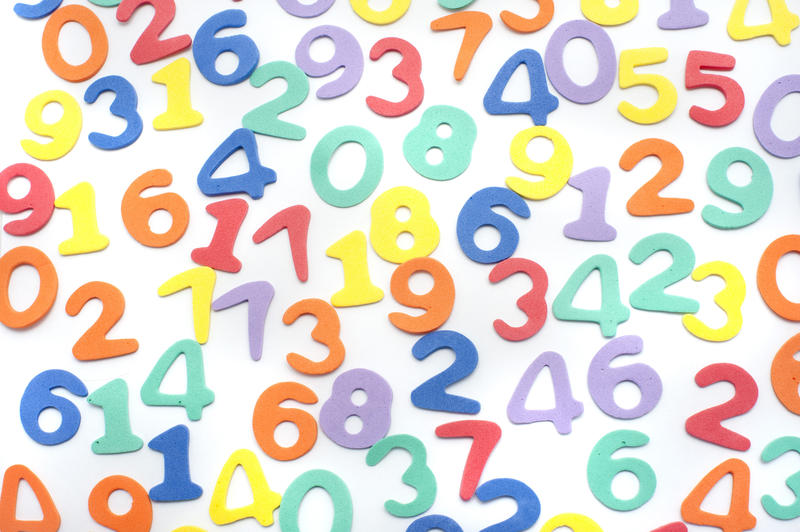 Colourful numbers background randomly scattered on white for a decorative educational backdrop