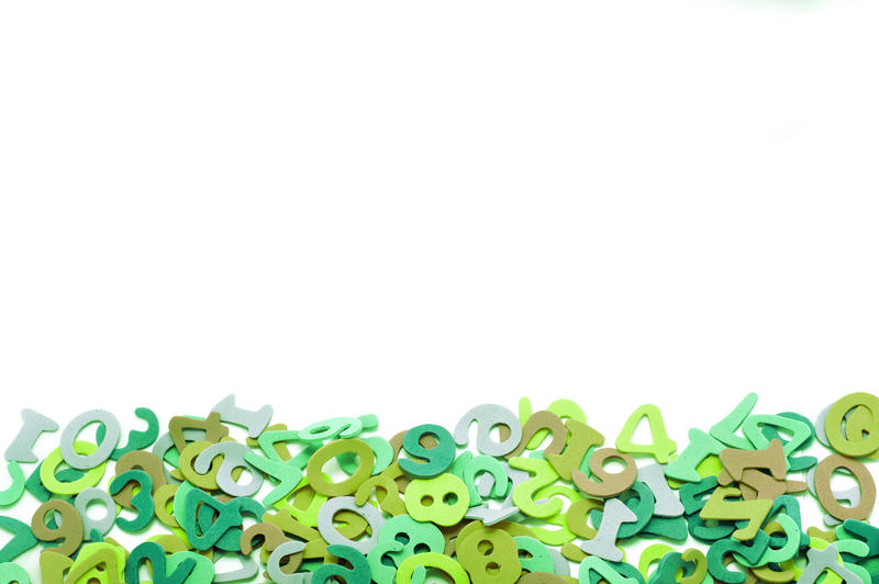 Random pile of colourful green numbers forming a lower border against a white background with copyspace for your text