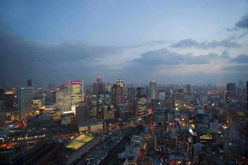 big city lights and tall buildings of osaka by night - pictured from the Umeda Sky Building