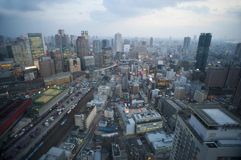 a panoramic view of buildings in central osaka, seen from the Umeda Sky Building