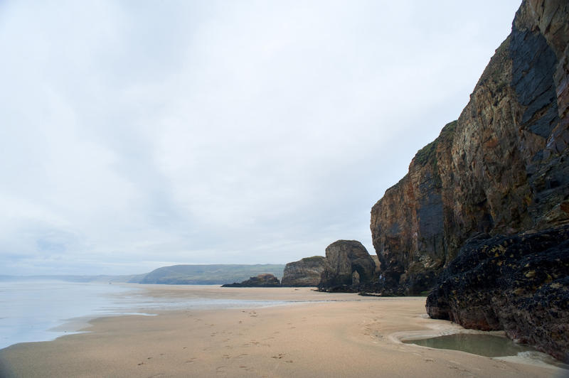 View along the deserted sandy beach and bay at Perran Beach, Perranporth, Cornwall a popular tourist and recreation destination