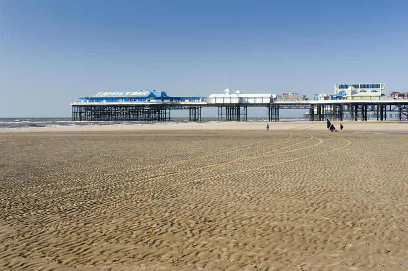 Looking across the wide sandy beach towards the Centre Pier at Blackpool, Lancashire, England