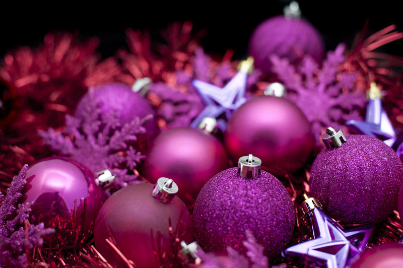 Purple Christmas celebration with a variety of ornaments, baubles and tinsel in random array for your festive background