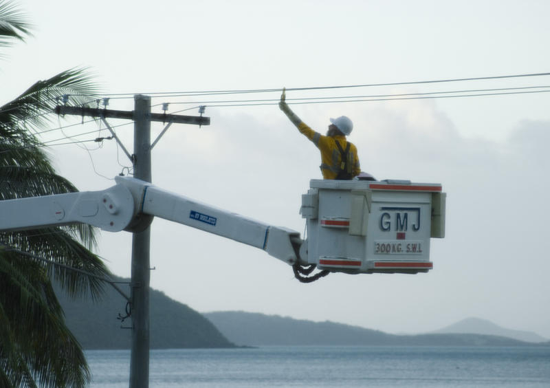 an electrical engineer working on a power lines using a lift platform