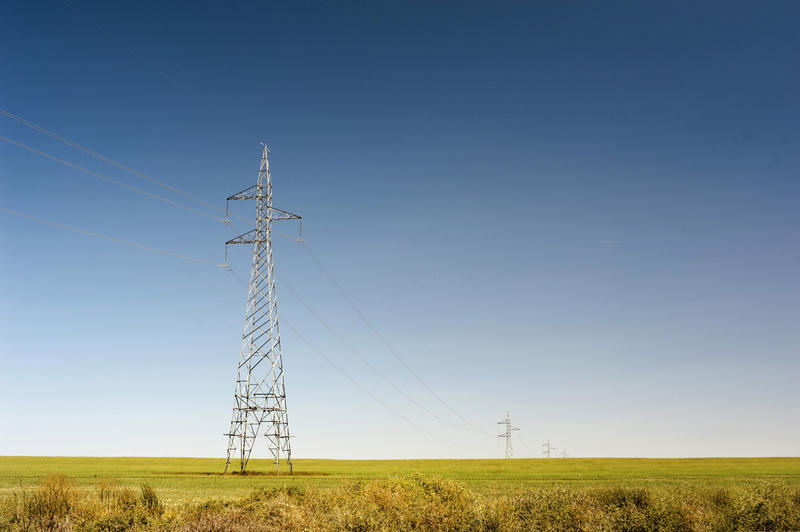 high voltage power cables sending electric across the countryside