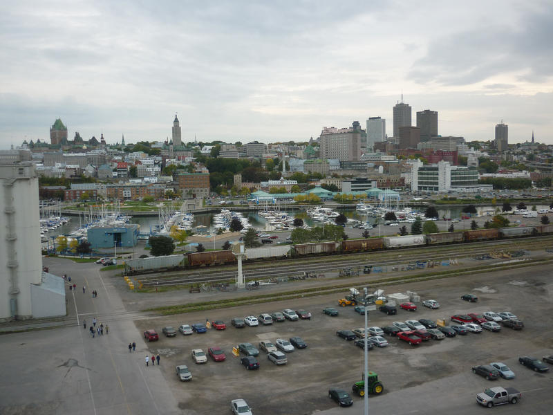 View of Quebec City waterfront with a parking lot, the pleasure boat marina and the buildings and landmarks of the city on the horizon