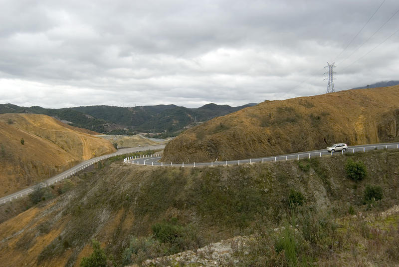 road winding its way down a mining scarred landscape towards queenstown tasmania