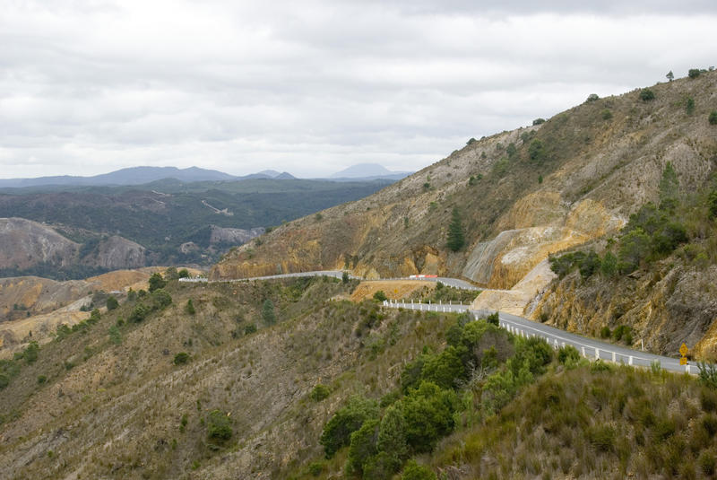 road winding its way down mining spoil scarred landscape to queenstown tasmania