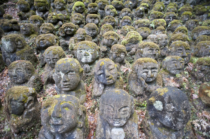 hundereds of small stone statues covered in moss and lichen at Otagi Nenbutsu-ji temple, Japan
